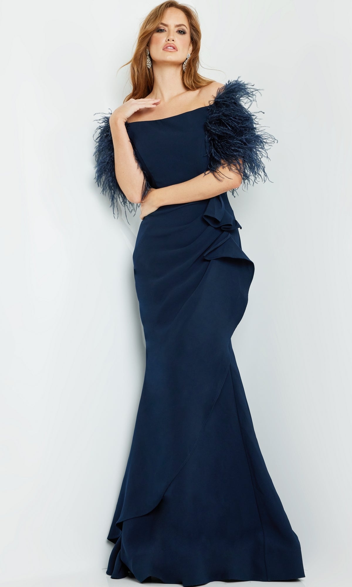 A woman poses against a light background in the Jovani Feather-Trim Long Formal Dress 09154, a navy blue, off-the-shoulder gown featuring elegant feather sleeves.